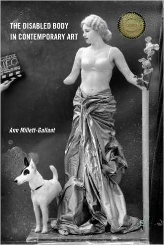 Picture depicts the black and white cover of Ann Millett Gallant’s book “The Disabled Body in Contemporary Art.” The illustration is a reproduction of Joel Peter Witkin’s 2003 photograph “First Casting for Milo.” The image shows a female model with shortened arms, standing, her skin painted white to resemble marble. She wears a white-powdered wig of wavy hair styled into a low bun; a white, structured bra; and a grey, heavily wrinkled large piece of fabric that is bunched and cinched at her waist to create a floor-length skirt. Her head is turned in profile to the viewer’s left. Her right arm, shortened just below the elbow, rests slightly away from the right side of her body. Her left arm, shortened above the wrist, extends from her left side and rests on the top of a pole. A branch with flowers emerges from the pole. She stands on a marble pedestal. The top is barely discernible. A small dog stands at an angle beside her, at her feet, and to the viewer’s left on the pedestal. The pointy-eared, squat dog is completely white except for black patches around his eyes and his left ear. The dog looks to the viewer’s left. In the upper left, across from the model’s right shoulder is a disembodied hand holding a film director’s clapboard upside down. Grey and silver splotches create a spectral background. In the top left corner, is the text: The Disabled Body in Contemporary Art. Above the head of the dog and in the center-left edge of the cover is the text: Ann Millett Gallant. [end of description]