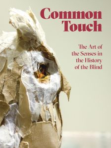 Picture shows the catalog cover illustrated with a profile, close-up of Teresa Jaynes’s Gift #1, a brown and white paper owl. Text in red letters is printed to the upper right of the image of the owl. Text reads: Common Touch [next line] The Arts of the Senses in the History of the Blind. [end of description]